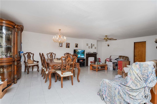 dining space with ceiling fan with notable chandelier
