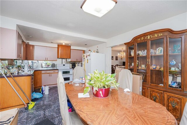 2594 40th St, Woodside, NY 11377 - dining space with a chandelier