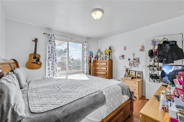 bedroom featuring access to outside and wood finished floors