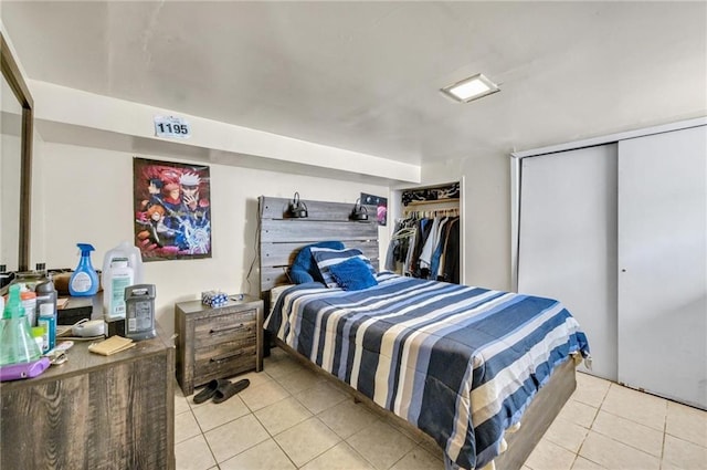 bedroom with two closets and light tile patterned flooring