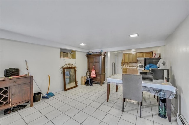 dining area featuring a baseboard heating unit, light tile patterned floors, and a wall unit AC