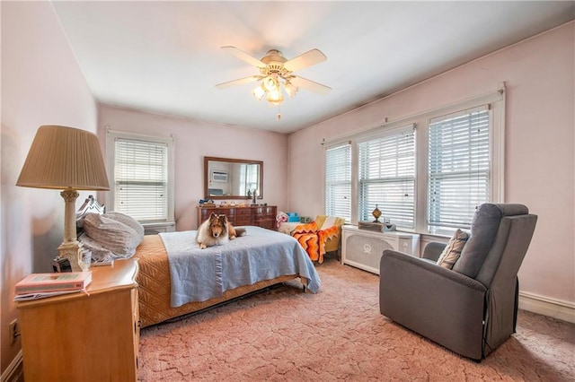 bedroom featuring baseboards, a ceiling fan, and carpet flooring