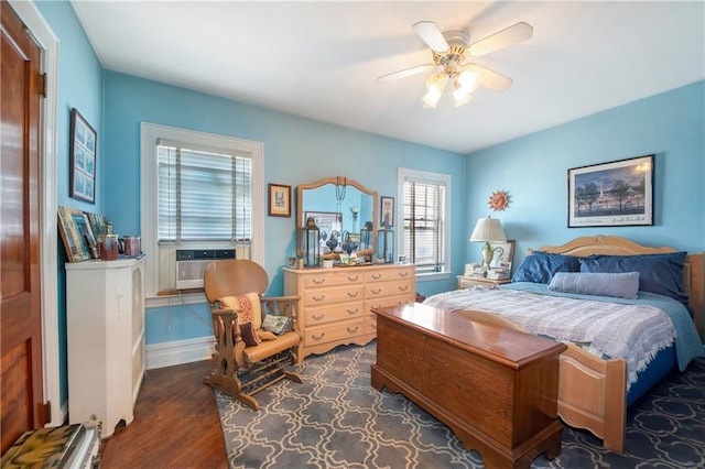 bedroom with dark wood-type flooring, cooling unit, baseboards, and a ceiling fan