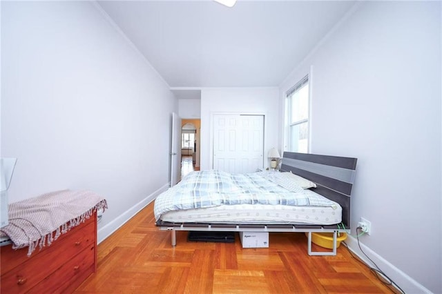 bedroom with baseboards and a closet