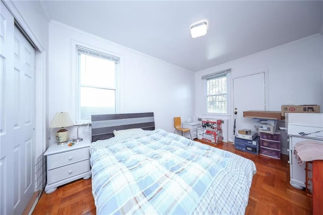 bedroom featuring crown molding and a closet