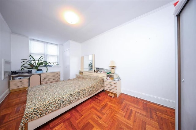 bedroom with baseboards and crown molding