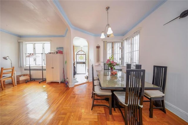 dining space featuring radiator heating unit, baseboards, arched walkways, and ornamental molding