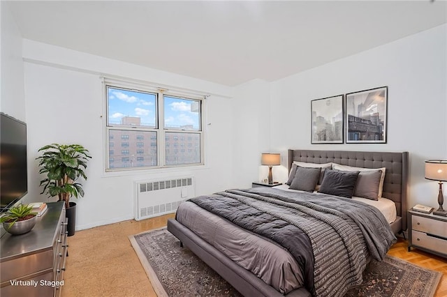 bedroom with radiator and baseboards