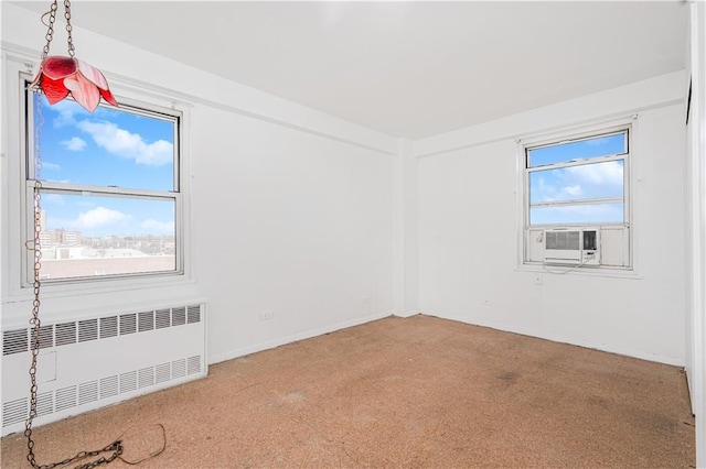 carpeted spare room with cooling unit and radiator