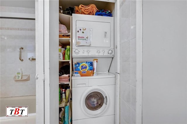 washroom with stacked washing maching and dryer