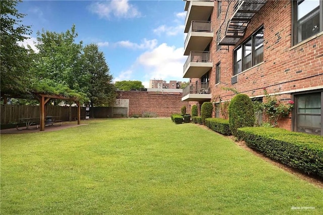 view of yard featuring a patio area, fence, and a pergola