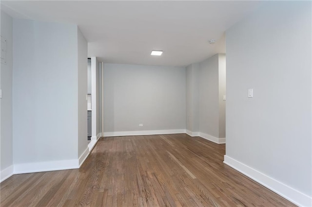 unfurnished room featuring baseboards and wood finished floors