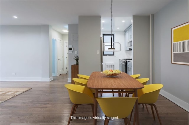 dining room with recessed lighting, baseboards, and wood finished floors