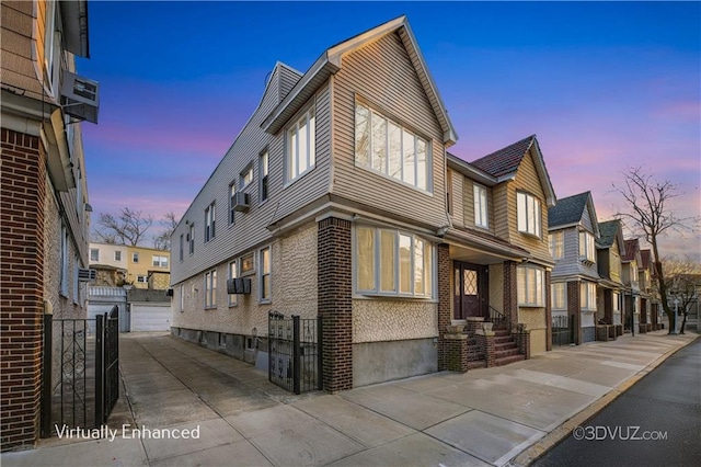 view of home's exterior with a residential view, an outdoor structure, and brick siding