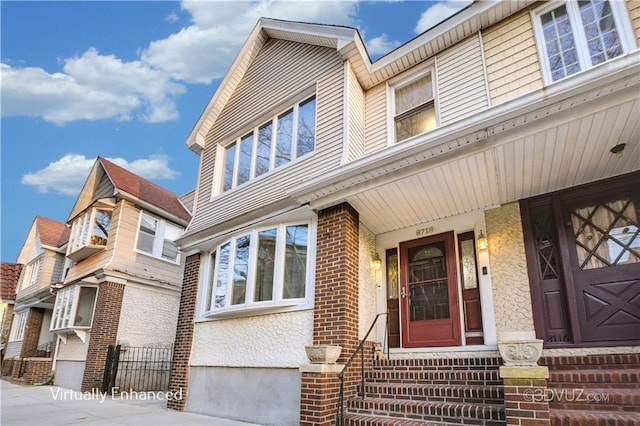 doorway to property featuring brick siding