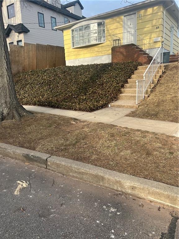 view of side of home featuring fence