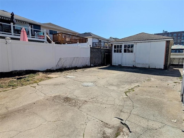 view of patio with an outdoor structure and fence