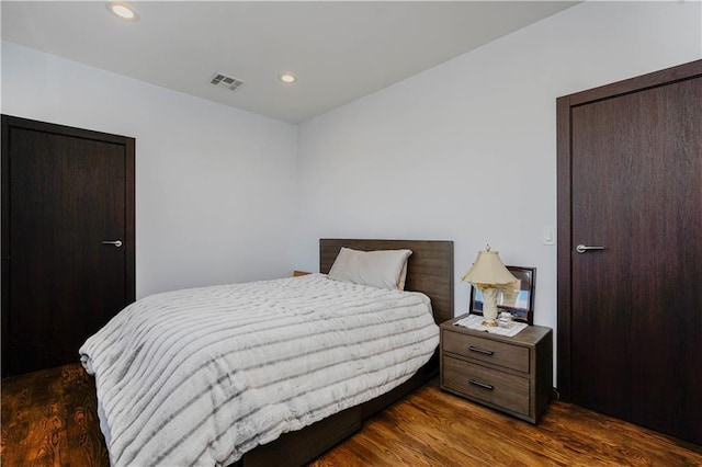 bedroom with wood finished floors, visible vents, and recessed lighting