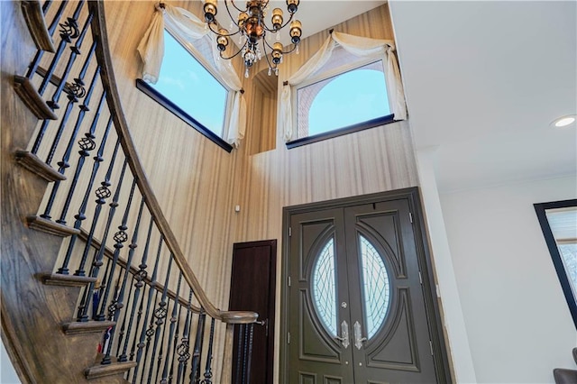 entryway featuring french doors, stairway, recessed lighting, and a notable chandelier