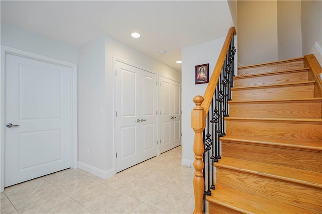 stairway featuring recessed lighting, baseboards, and tile patterned floors