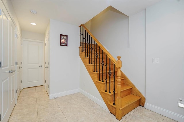 stairs with tile patterned flooring, baseboards, and recessed lighting