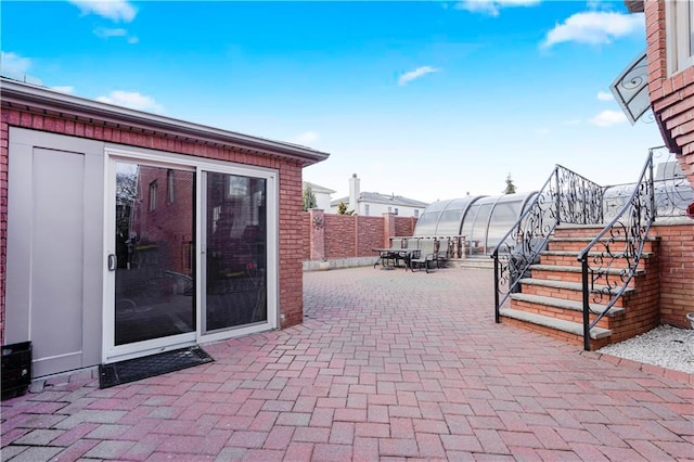 view of patio / terrace with fence and an outdoor structure