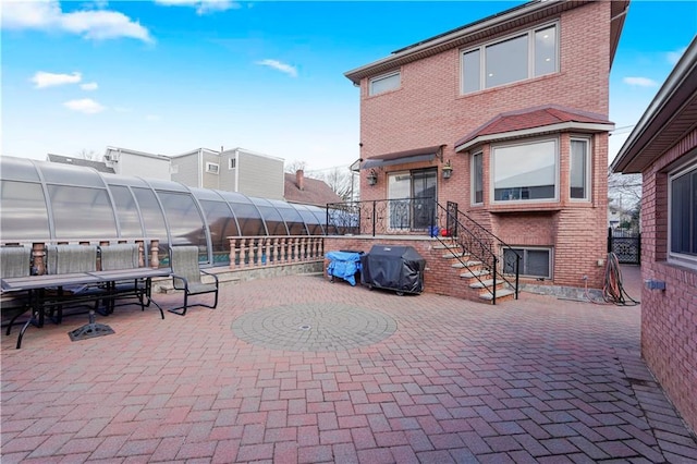 view of patio with grilling area, an exterior structure, and an outdoor structure