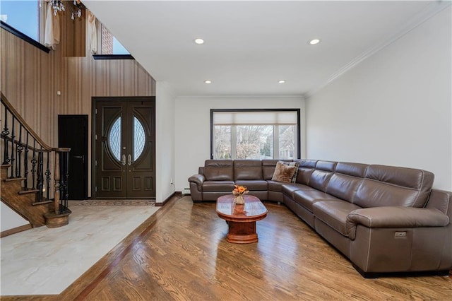 living area featuring ornamental molding, recessed lighting, stairway, and wood finished floors