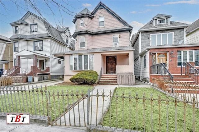 view of front of house with a fenced front yard and a front lawn