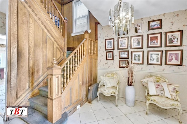 living area with radiator, an inviting chandelier, a wealth of natural light, and wallpapered walls