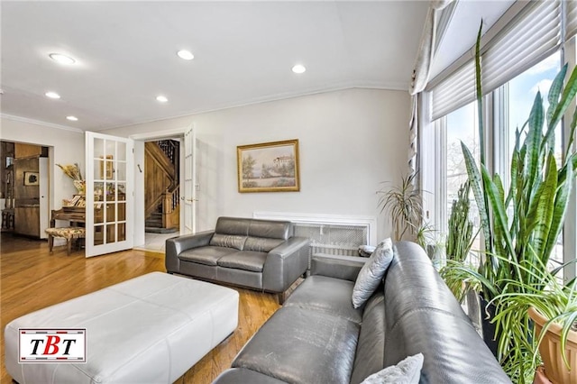 living room featuring crown molding, french doors, wood finished floors, and recessed lighting