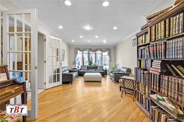 living area with ornamental molding, light wood-type flooring, french doors, and recessed lighting