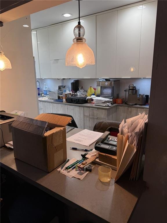 kitchen with pendant lighting, recessed lighting, modern cabinets, and white cabinets