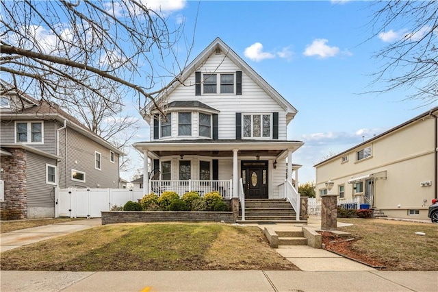 view of front of property with a porch and a front yard