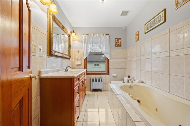 bathroom with a jetted tub, radiator, tile walls, and tile patterned floors