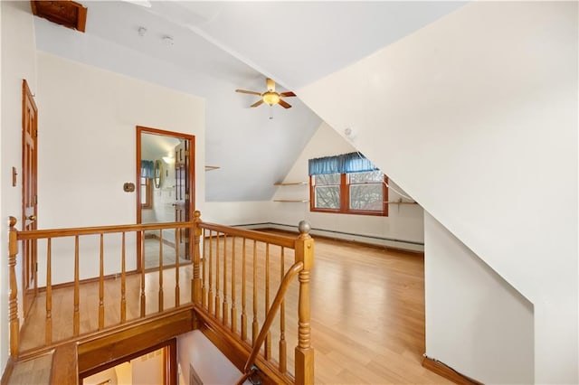 additional living space featuring ceiling fan, vaulted ceiling, and wood finished floors