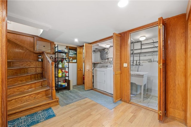 interior space with recessed lighting, stairway, light wood-type flooring, electric panel, and washer and clothes dryer