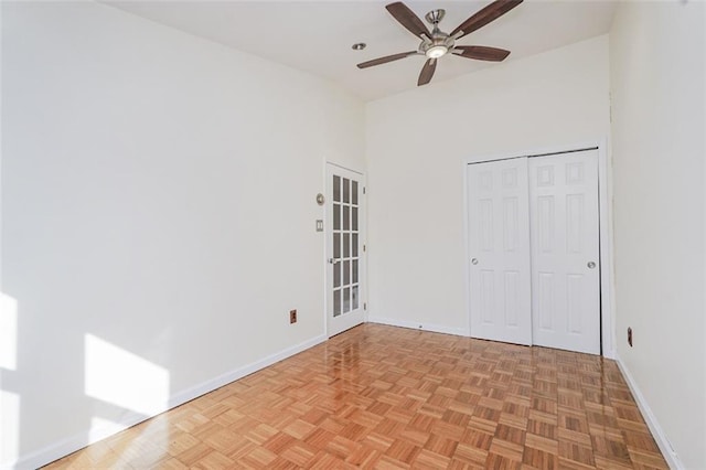 unfurnished bedroom with a closet, ceiling fan, and baseboards