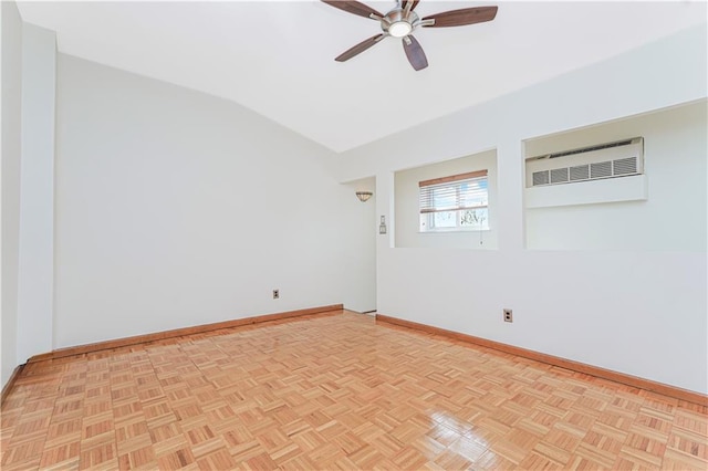 empty room with vaulted ceiling, a wall mounted AC, a ceiling fan, and baseboards