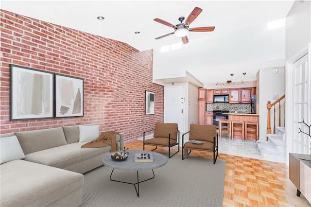 122 Prospect Park SW Unit 10, Brooklyn, NY 11218 - living room with stairs, brick wall, and ceiling fan