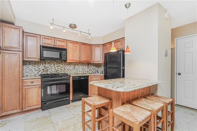 kitchen with light stone counters, hanging light fixtures, black appliances, a kitchen bar, and tasteful backsplash