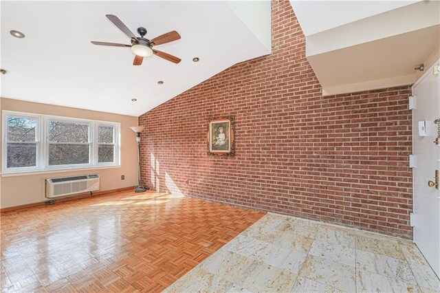 empty room featuring lofted ceiling, an AC wall unit, brick wall, and a ceiling fan