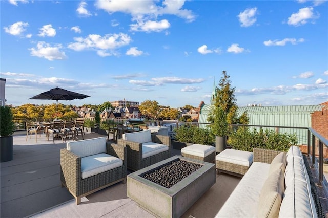 view of patio featuring outdoor dining space, an outdoor living space with a fire pit, and fence