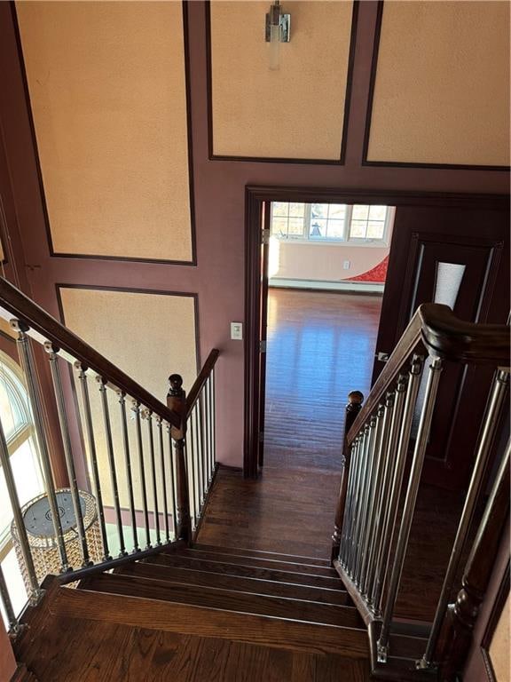 staircase with wood finished floors