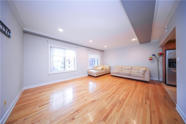 unfurnished living room with ornamental molding, recessed lighting, baseboards, and light wood finished floors