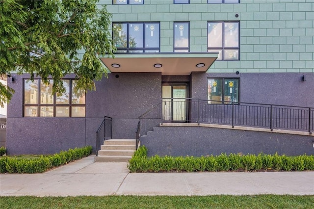 property entrance with stucco siding