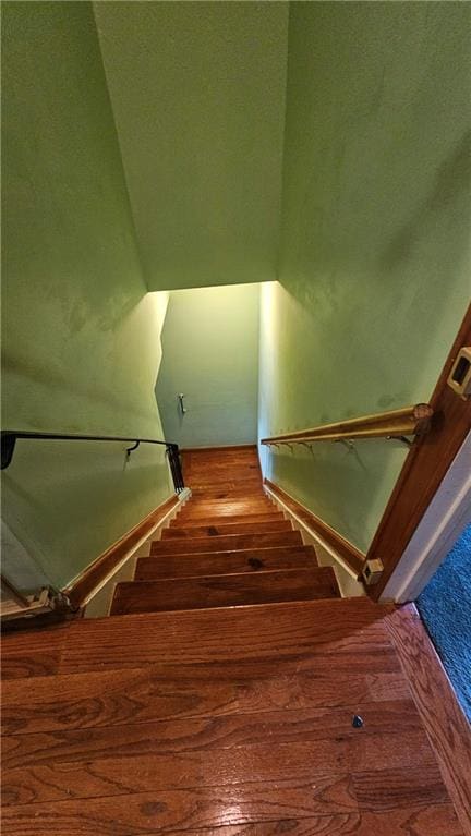 stairway featuring wood-type flooring