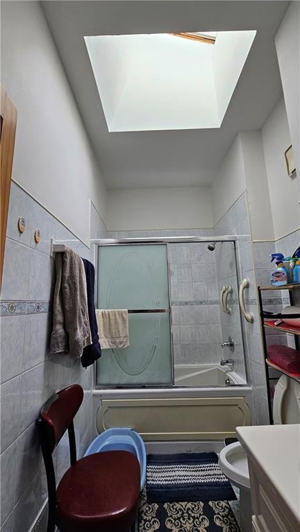 22 Long Pond Ln, Staten Island, NY 10304 - full bathroom with toilet, a skylight, combined bath / shower with glass door, vanity, and tile walls
