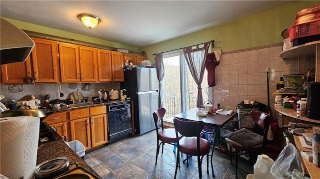 kitchen with range hood, dishwasher, freestanding refrigerator, and brown cabinets