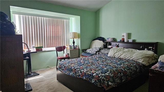 bedroom featuring baseboards and carpet flooring